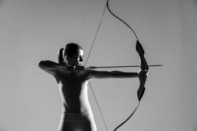 Woman shooting archery bow