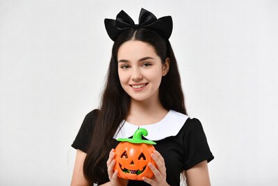 Girl holding jack-o-lantern pumpkin