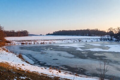 Frozen Lake with Wooden Pier in Snow
