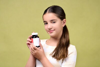 Girl holding medicine bottle