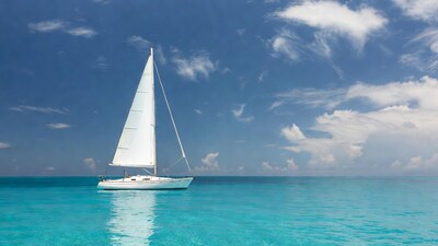 White sailboat on turquoise sea