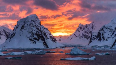 Antarctic Mountains at Sunset with Icebergs
