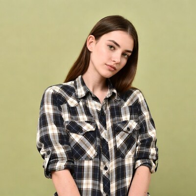 Woman in plaid shirt on green background