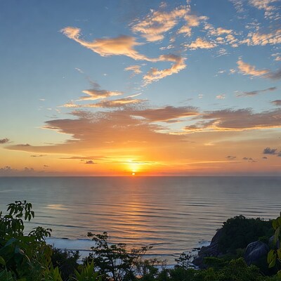 Sunset over ocean from tropical cliff