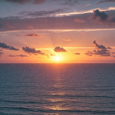 Sunset over ocean with clouds