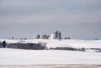 Grain Silos on Snowy Farm Field