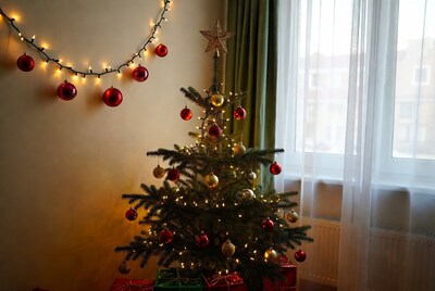 Lit Christmas tree with ornaments and gifts