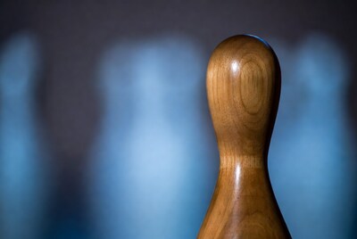 Wooden Bowling Pin on Blue Background
