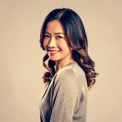 Smiling Asian woman in gray cardigan