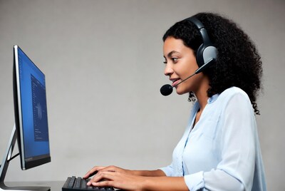 African-American woman in headset working at computer