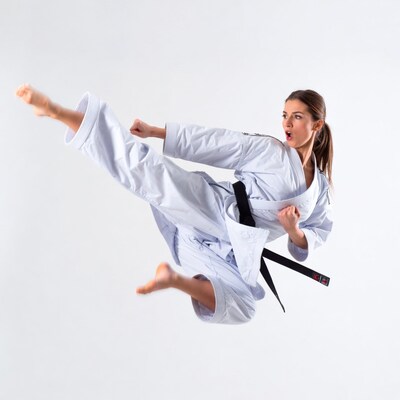 Woman performing high karate kick