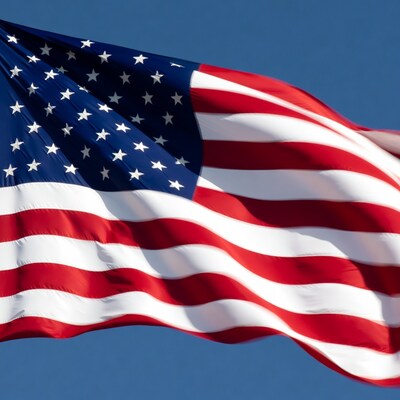 American Flag Waving Against Blue Sky