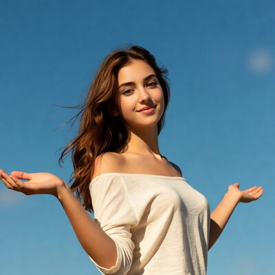 Young woman arms outstretched blue sky