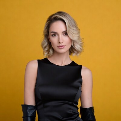 Blonde woman in black dress yellow background