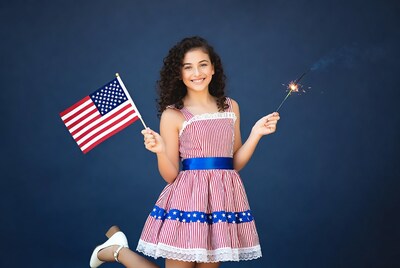Girl holding flag and sparkler