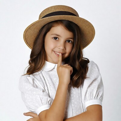 Girl shushing with finger to lips in straw hat