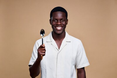 African man holding spoon