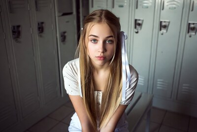 Blonde girl with ribbon in school lockers