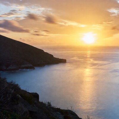 Sunset over ocean cliffs