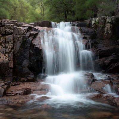 Waterfall cascading over mossy rocks
