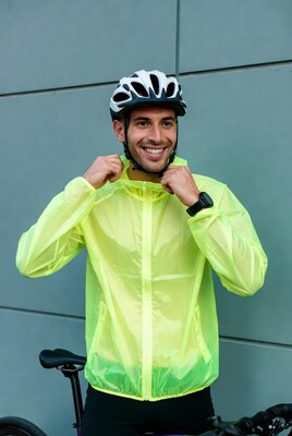 Man in yellow rain jacket with bike