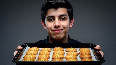 Young man holding tray of cookies