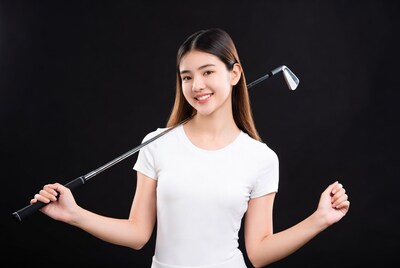 Asian woman holding golf club