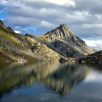Mountain peak reflecting in alpine lake