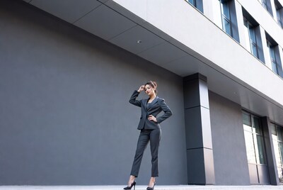 Asian woman in gray suit outside building