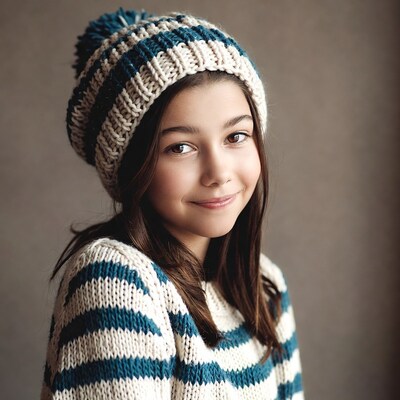 Girl smiling in knit beanie sweater