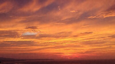 Vibrant orange sunset over ocean