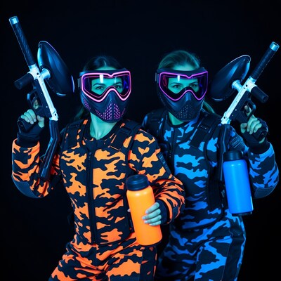 Two women in neon paintball gear