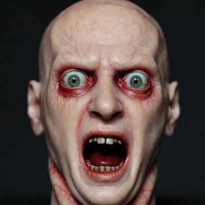 Bald zombie man screaming with green eyes