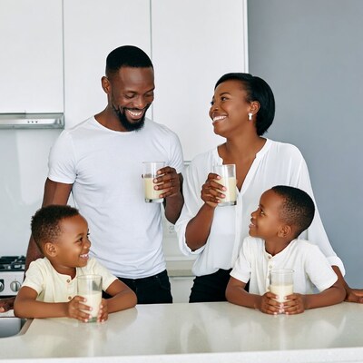 African family drinking milk in kitchen