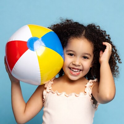 Black girl holding beach ball