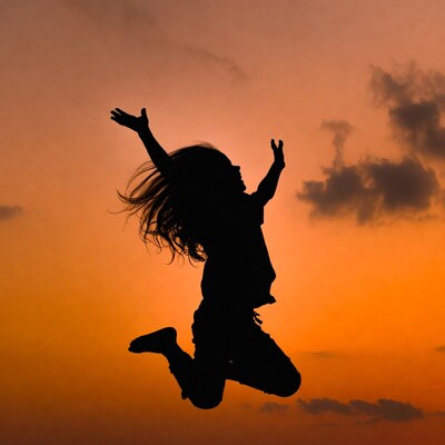 Girl jumping silhouette at sunset