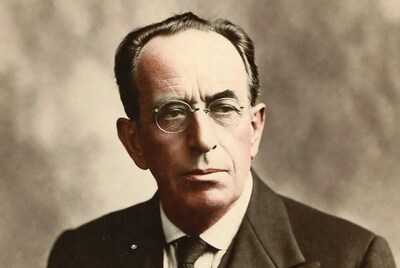 Elderly man in suit with glasses