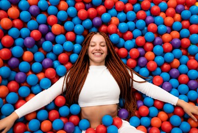 Smiling woman in colorful ball pit
