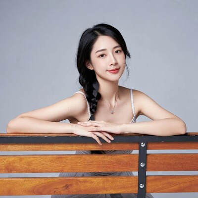 Asian woman leaning on wooden bench