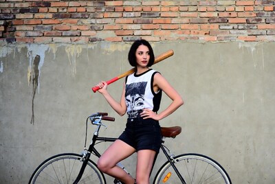 Woman with bat on bicycle