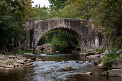 Stone Arch Bridge over Forest Stream