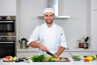 Chef cutting vegetables on kitchen counter