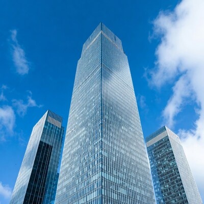 Three Glass Skyscrapers Against Blue Sky