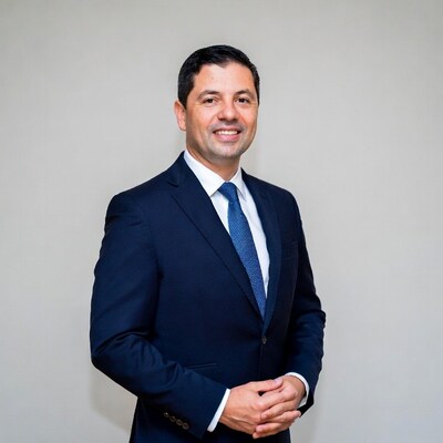 Man in navy suit smiling