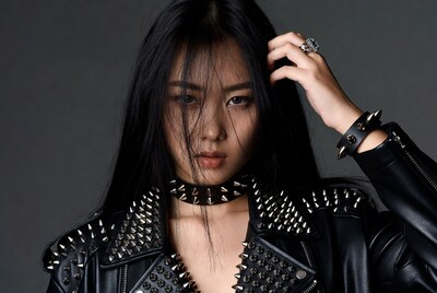 Asian woman in spiked leather jacket