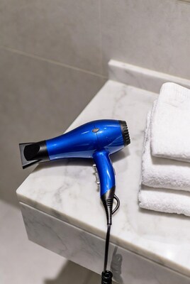 Blue hair dryer on marble bathroom counter