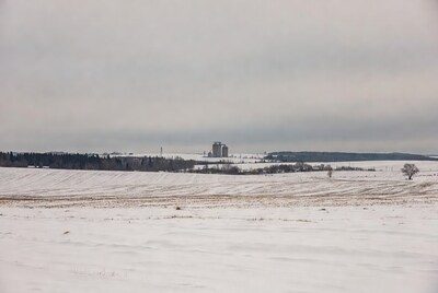 Grain Silos in Snowy Fields