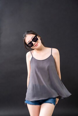 Asian woman in sunglasses tilting head