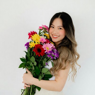 Asian woman holding colorful flower bouquet