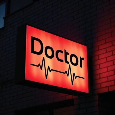 Red Doctor Sign with Heartbeat on Brick Wall